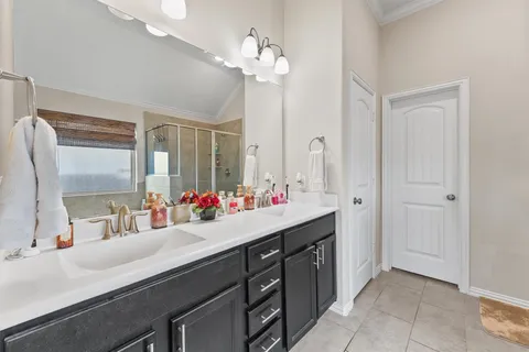 a bathroom with a double vanity sink and a mirror