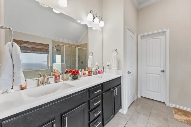 a bathroom with a double vanity sink and a mirror
