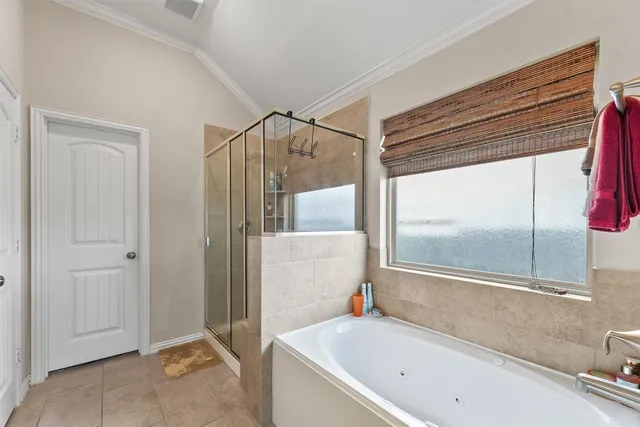a bathroom with a tub and a shower