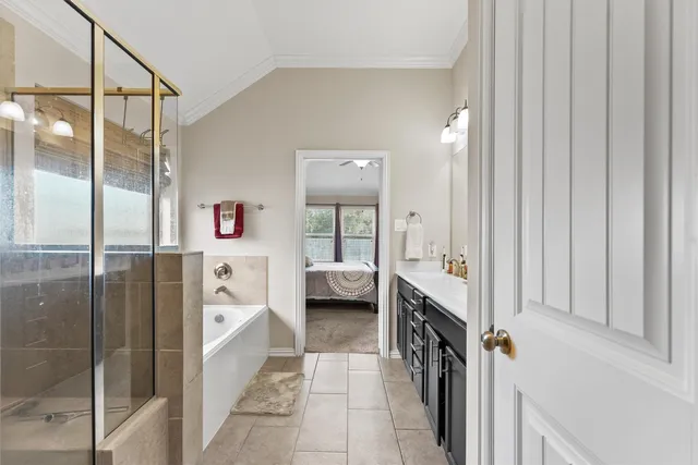 a en suite bathroom with a tub shower and sink