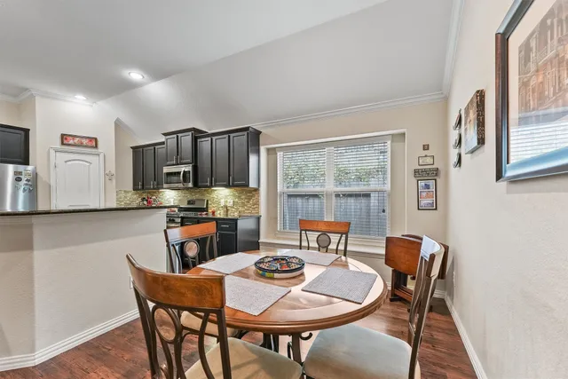 a dining room with furniture and window