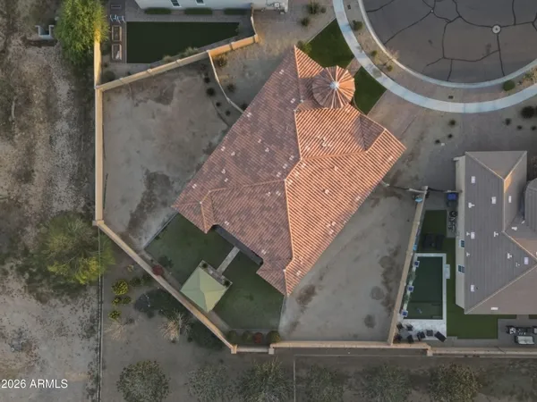 an aerial view of a house with a yard