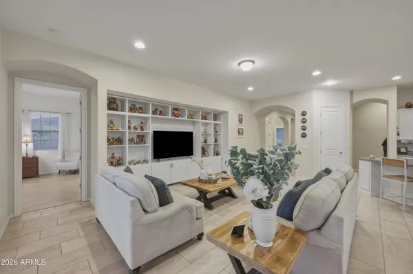 a living room with furniture or chandelier and a flat screen tv