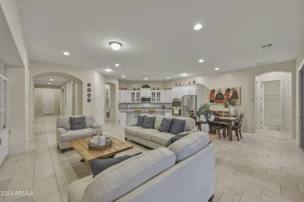 a living room with furniture and a view of kitchen appliances