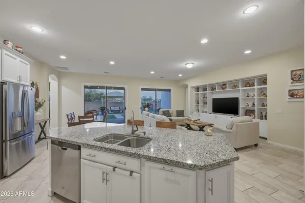 a kitchen with center island a sink and a refrigerator