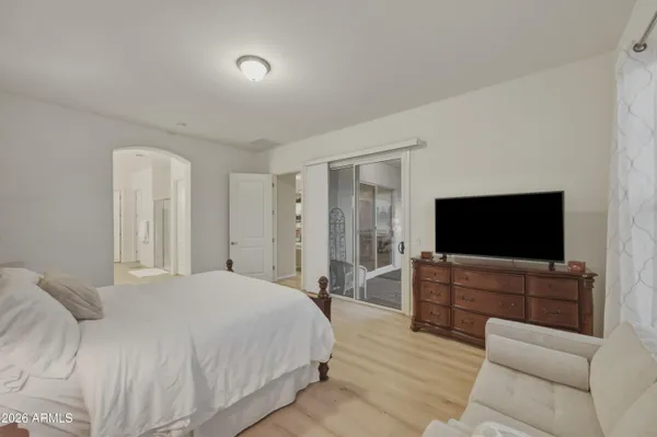 a bedroom with a bed and a flat screen tv