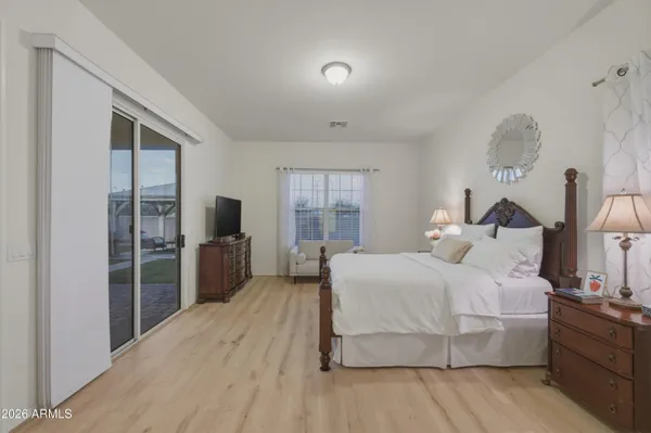 a bedroom with a large bed and a flat screen tv