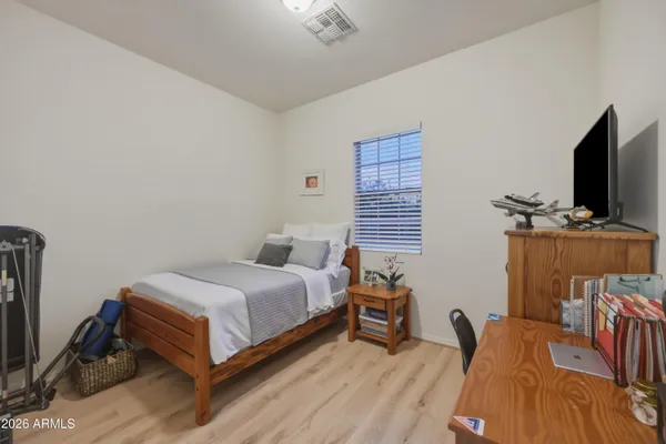 a bedroom with a bed and a flat screen tv