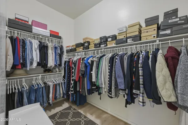 a view of walk in closet with clothes