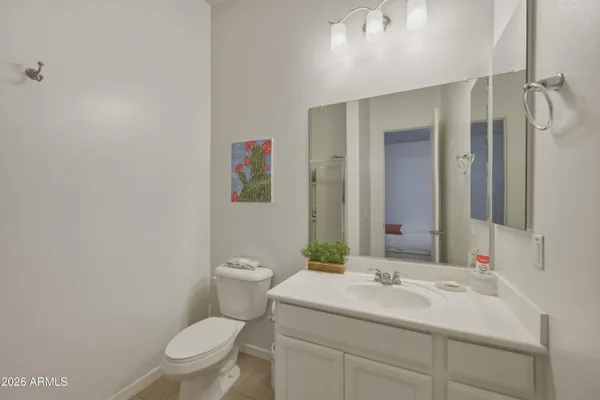 a bathroom with a sink vanity mirror and toilet