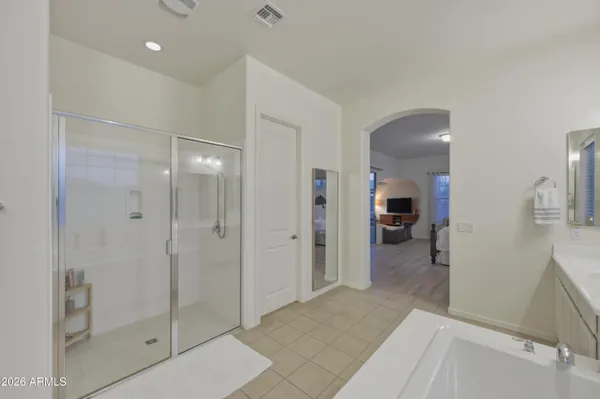 a bathroom with a shower and a glass door