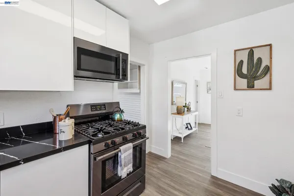 a kitchen with stainless steel appliances a stove a sink and cabinets