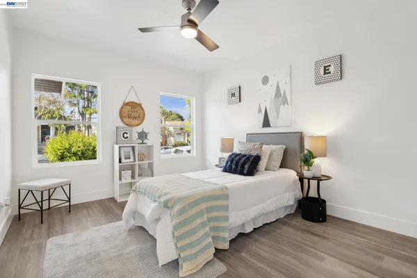 a bed room with a bed and a painting on the wall