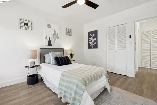 a bedroom with a bed and wall painting