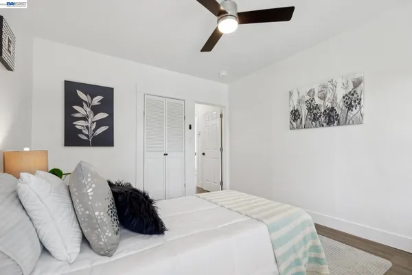 a bedroom with a bed and a potted plant