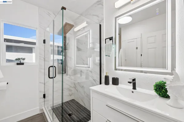 a bathroom with a bathtub and shower
