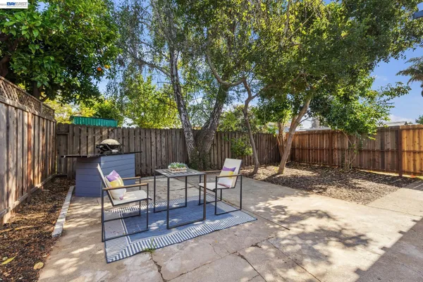 a backyard of a house with yard and outdoor seating