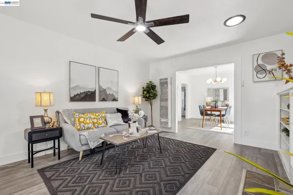 a living room with furniture and a wooden floor