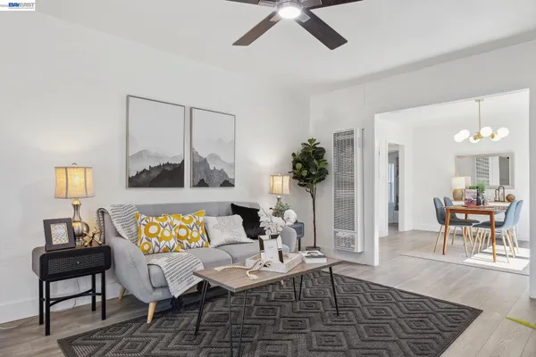 a living room with furniture and wooden floor