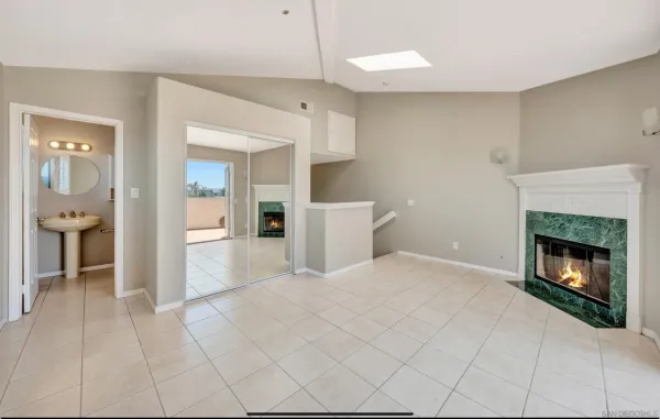 a view of a livingroom with a fireplace and cabinet