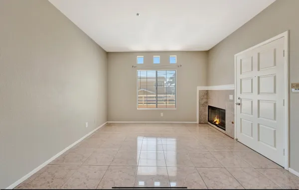 a view of a livingroom with a fireplace and window