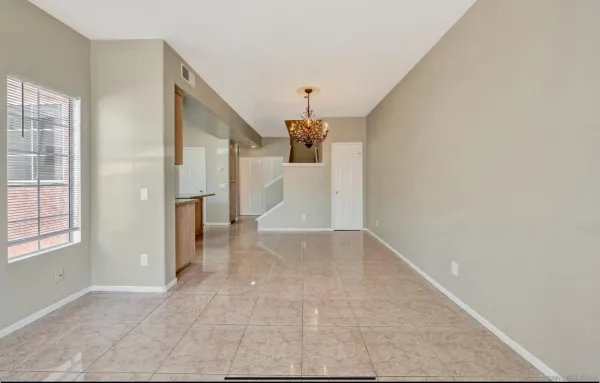 an empty room with windows and cabinet