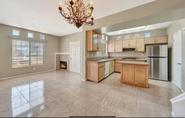 a kitchen with stainless steel appliances granite countertop a stove a sink a refrigerator and cabinets