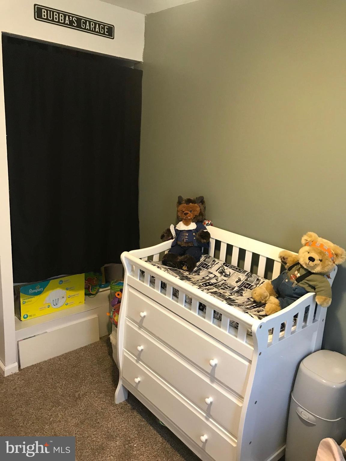 8180 Del Haven Road Baltimore, MD 21222 - Photo 18 of 29 a bed sitting in a room next to a window
