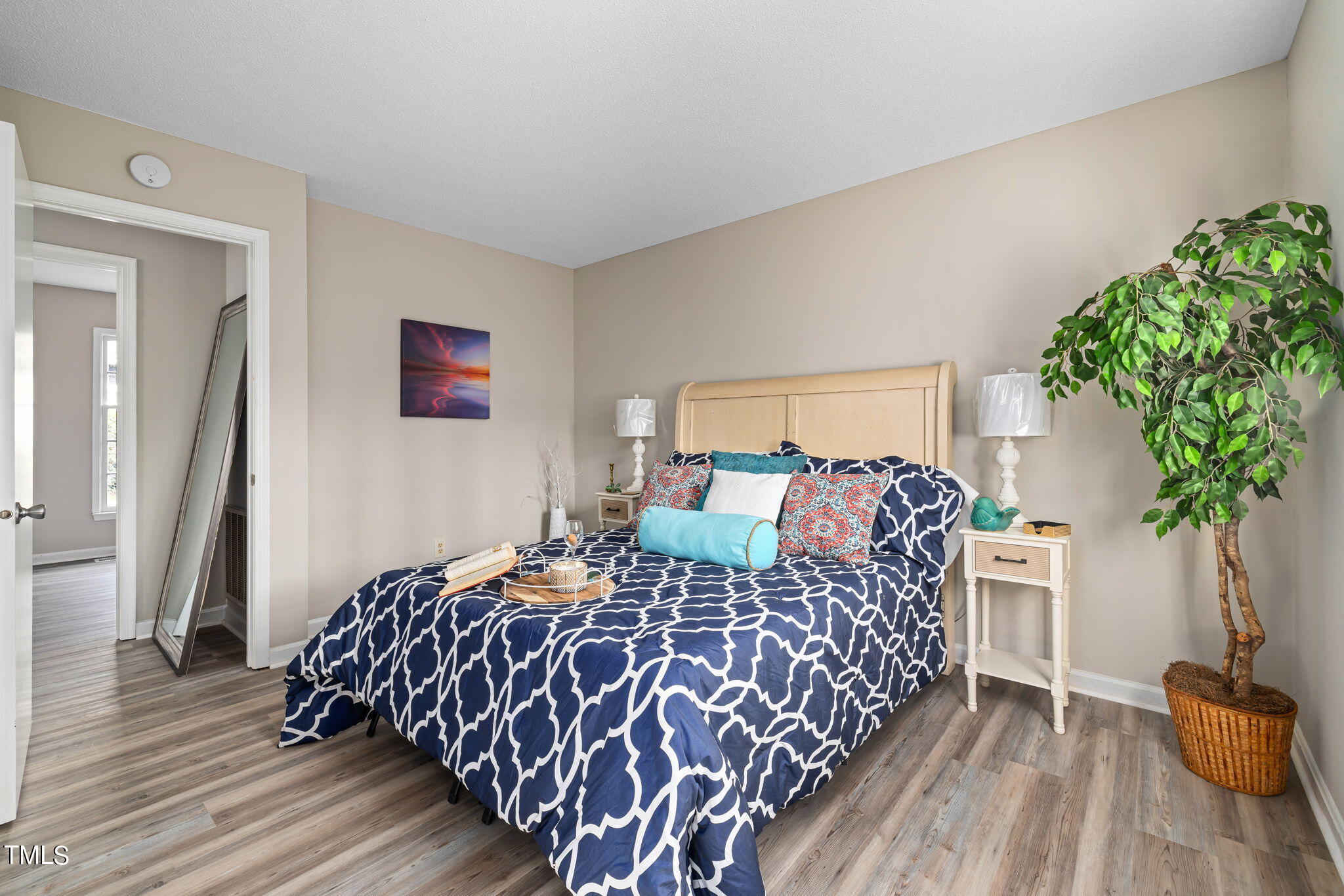 608 Old Farm Road Raleigh, NC 27606 - Photo 21 of 32 a bedroom with a large bed and a potted plant