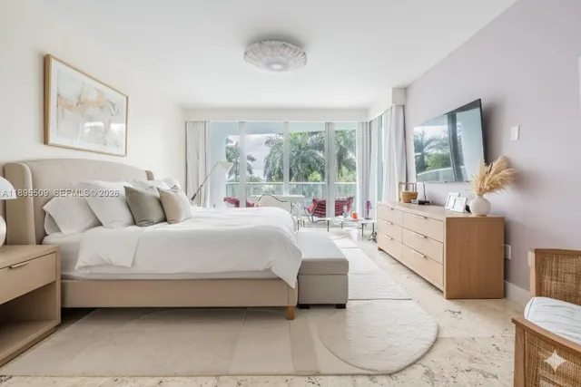 a bedroom with a large bed and a window