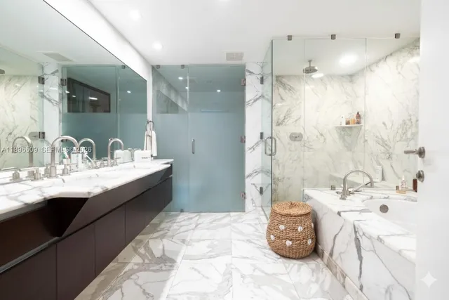 a bathroom with a double vanity sink mirror and shower