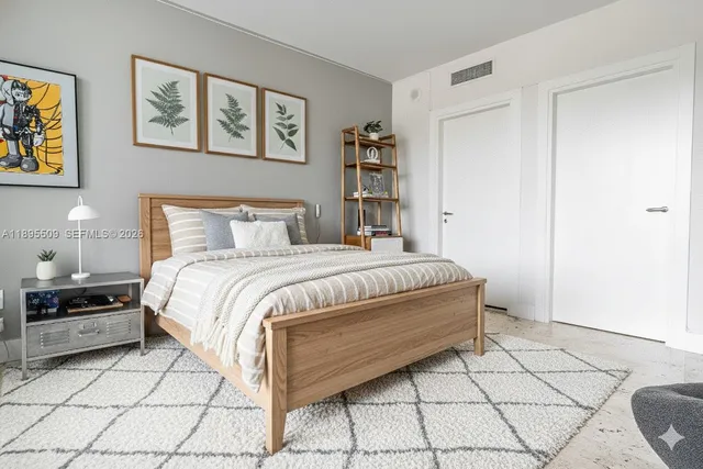 a bedroom with a bed and a cabinets