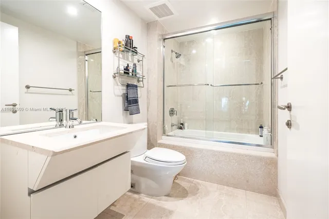 a bathroom with a sink toilet tub and shower