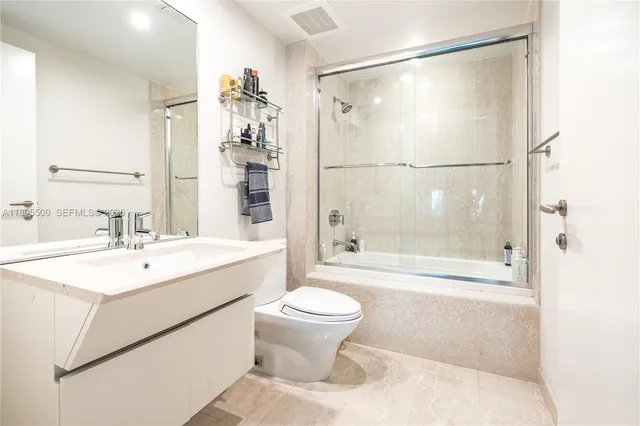 a bathroom with a sink toilet tub and shower