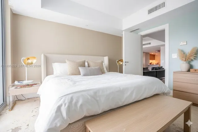 a bedroom with a bed and a mirror