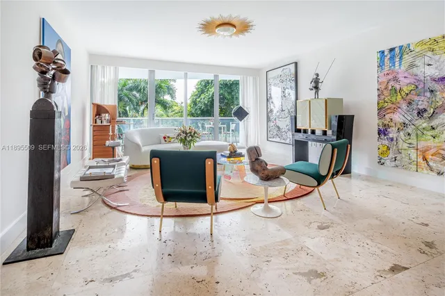 a living room with fireplace furniture and a floor to ceiling window