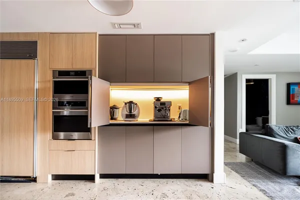 a kitchen with a refrigerator and a stove