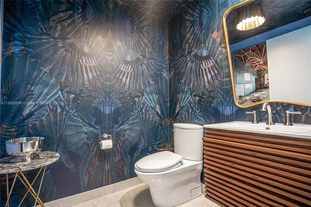 a white toilet sitting next to a bathroom sink