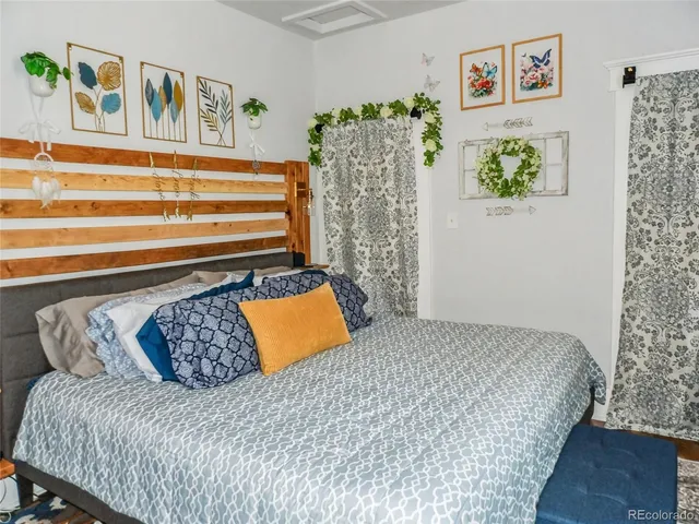 a bedroom with a bed and a couch