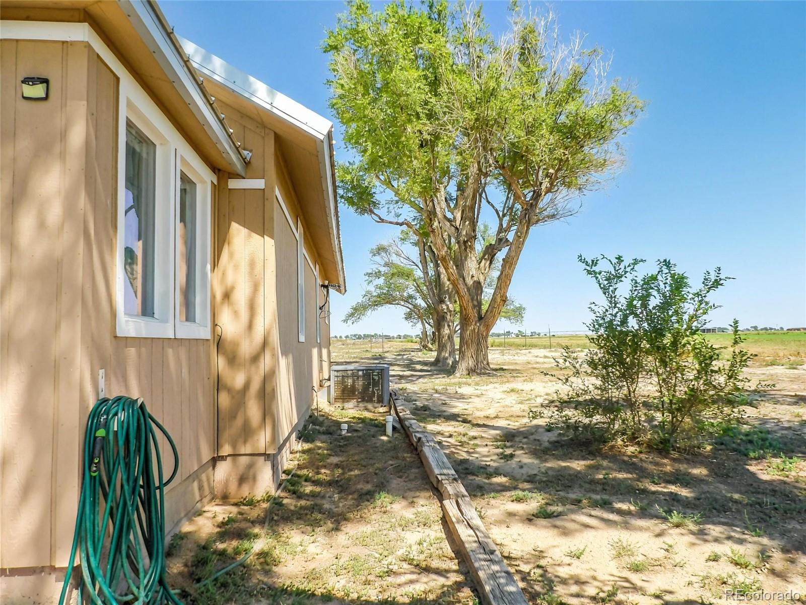7651 State Highway Las Animas, CO 81054 - Photo 19 of 25 a view of a yard with plants and large trees