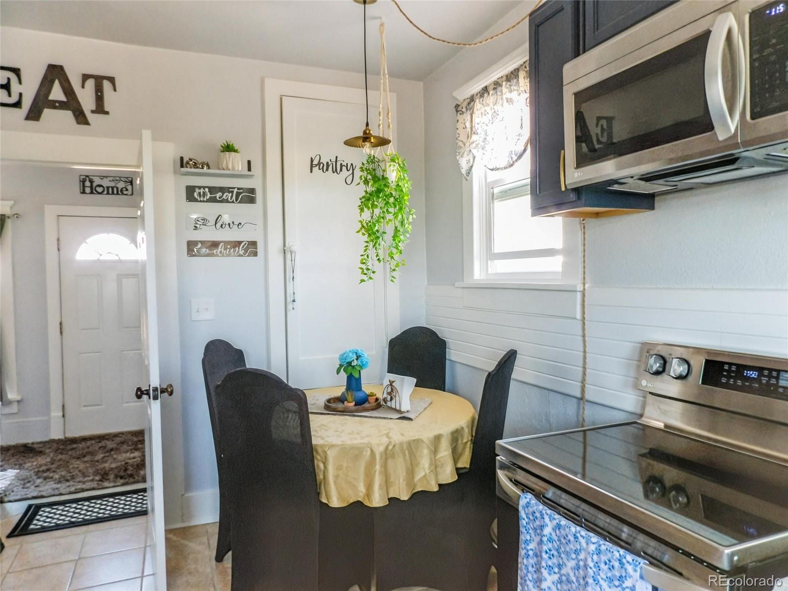 7651 State Highway Las Animas, CO 81054 - Photo 10 of 25 a kitchen with stainless steel appliances granite countertop a stove a microwave a sink a refrigerator dining table and chairs