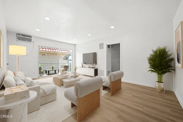 a living room with furniture potted plant and a window