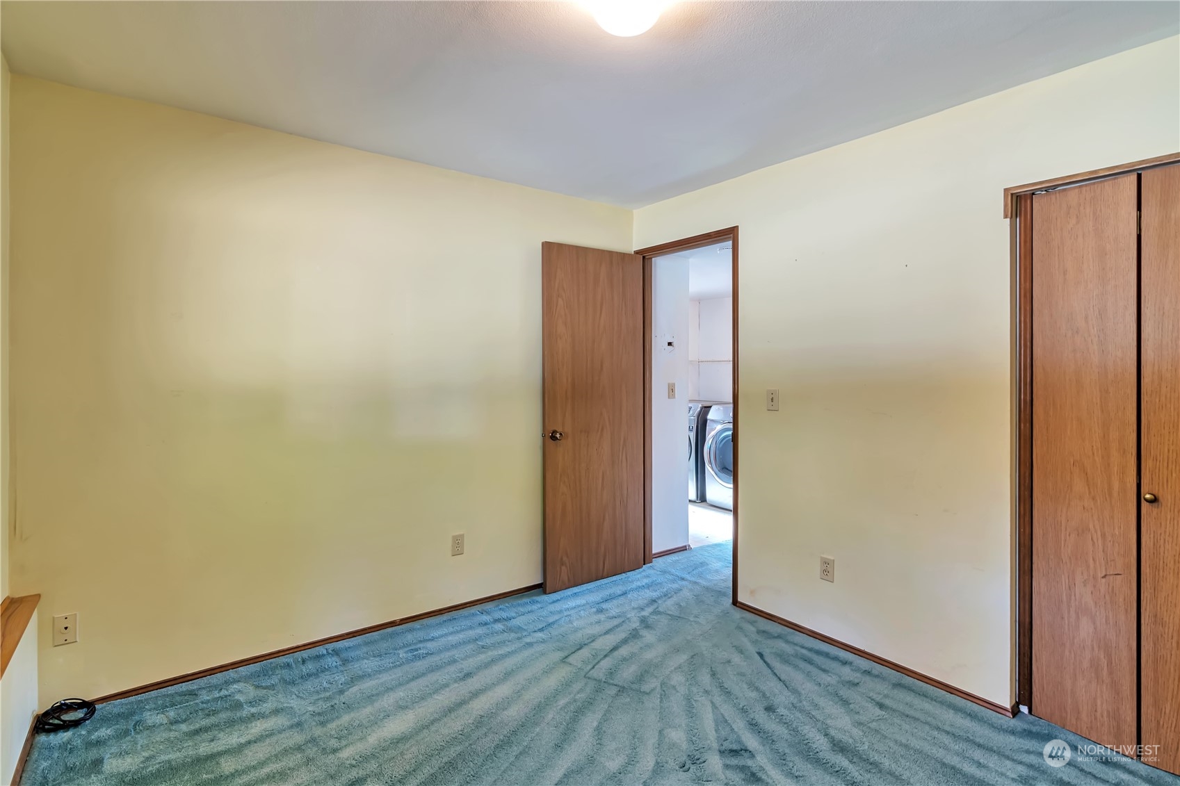 18330 26th Drive Southeast Bothell, WA 98012 - Photo 12 of 24 a view of an empty room with wooden floor and closet