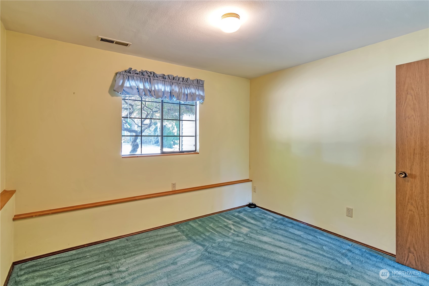 18330 26th Drive Southeast Bothell, WA 98012 - Photo 13 of 24 a view of an empty room with wooden floor and a window