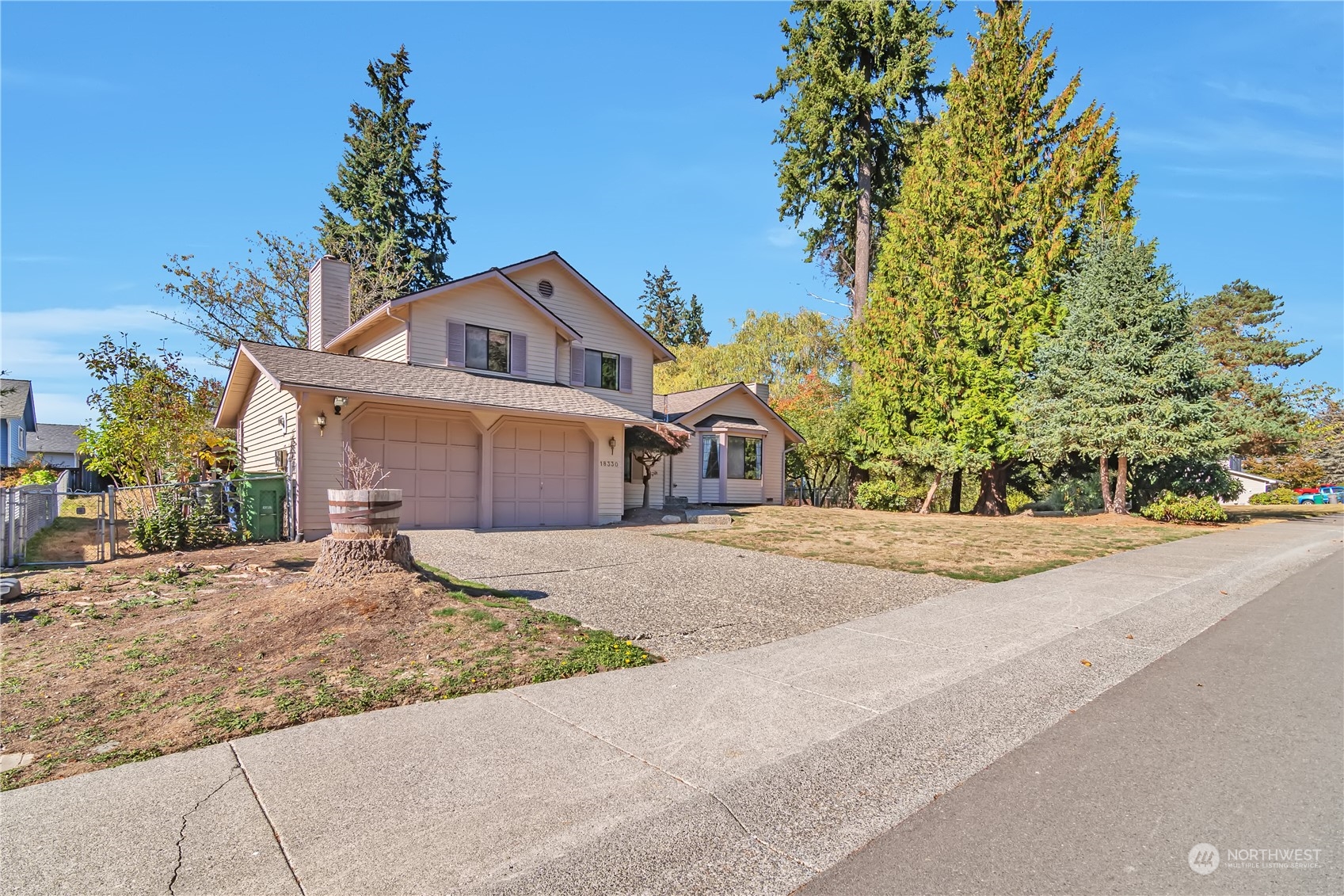 18330 26th Drive Southeast Bothell, WA 98012 - Photo 2 of 24 a front view of a house with a yard and garage