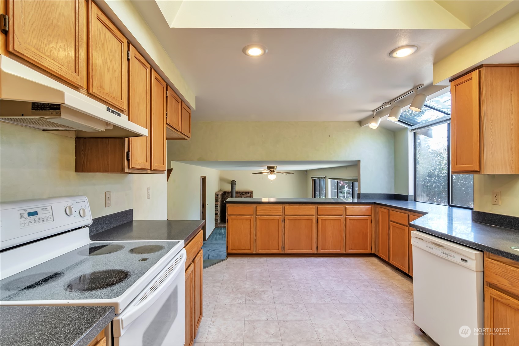 18330 26th Drive Southeast Bothell, WA 98012 - Photo 6 of 24 a kitchen with stainless steel appliances granite countertop a sink a stove and a refrigerator