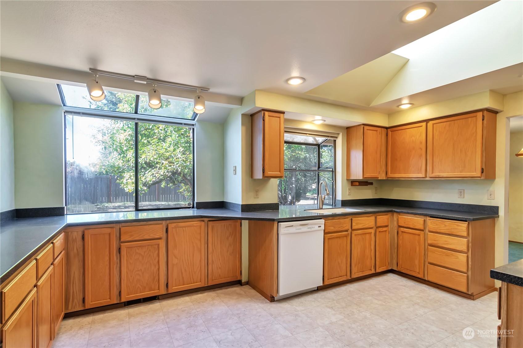 18330 26th Drive Southeast Bothell, WA 98012 - Photo 7 of 24 a large kitchen with stainless steel appliances granite countertop a sink and cabinets