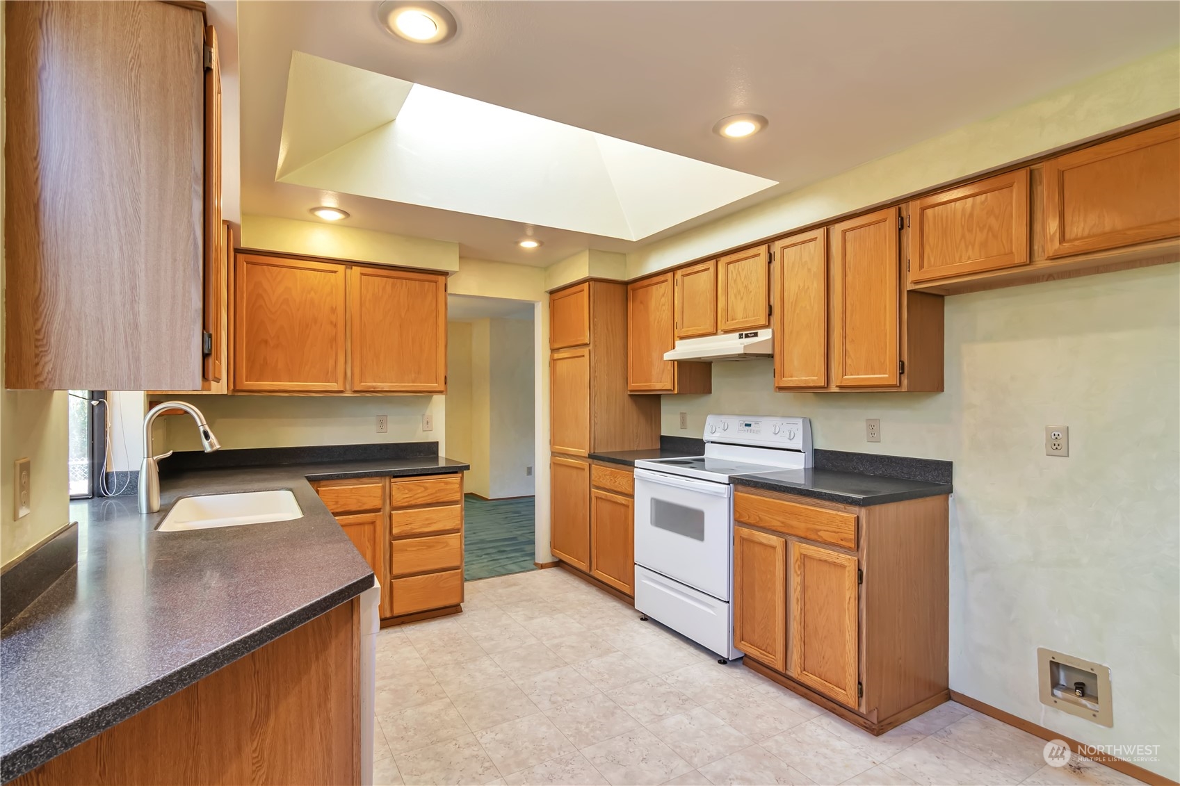 18330 26th Drive Southeast Bothell, WA 98012 - Photo 8 of 24 a kitchen with stainless steel appliances granite countertop a sink a stove and a refrigerator