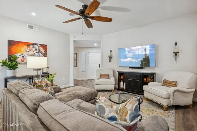 a living room with furniture and a wooden floor