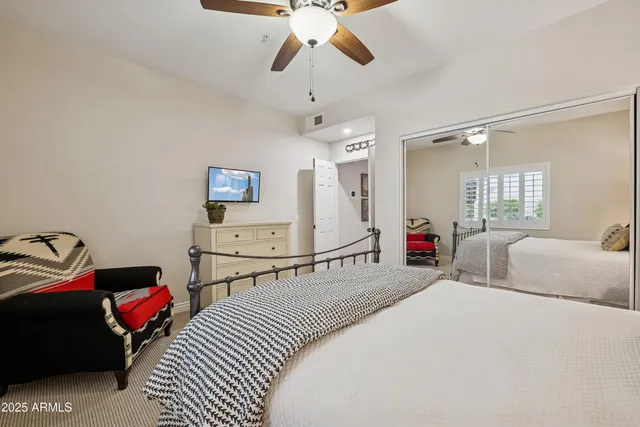 a bedroom with a bed and a chandelier